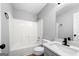 Bathroom featuring a shower-tub combo and a modern vanity with elegant fixtures at 8103 Rhodes Way, Riverdale, GA 30274