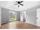Bedroom with hardwood flooring, tray ceiling, natural light, and neutral gray paint at 8103 Rhodes Way, Riverdale, GA 30274
