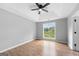 Bedroom with hardwood flooring, tray ceiling, natural light, and neutral gray paint at 8103 Rhodes Way, Riverdale, GA 30274