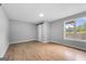 Spacious bedroom featuring wood-look floors, a barn door, and a window for natural light at 8103 Rhodes Way, Riverdale, GA 30274