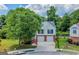 Charming two-story home with a well-manicured lawn, mature trees, and a two-car garage at 8103 Rhodes Way, Riverdale, GA 30274