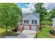 Attractive two-story home with two-car garage and mature tree on a well-maintained lawn at 8103 Rhodes Way, Riverdale, GA 30274