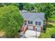 Aerial view of a home with a two-car garage and large tree at 8103 Rhodes Way, Riverdale, GA 30274