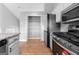 Kitchen view showing stainless appliances, granite counters, pantry and mosaic backsplash at 8103 Rhodes Way, Riverdale, GA 30274