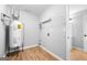 Neat laundry room with hot water heater, shelving, and hookups, and wood-look vinyl flooring at 8103 Rhodes Way, Riverdale, GA 30274