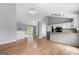 Open-concept living area with hardwood floors, modern kitchen, and vaulted ceiling at 8103 Rhodes Way, Riverdale, GA 30274