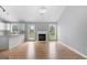 Bright living room features a fireplace, wood floors, lots of natural light, and an open floor plan at 8103 Rhodes Way, Riverdale, GA 30274