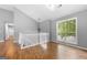Inviting living room with wood floors, large windows, modern lighting, and neutral paint at 8103 Rhodes Way, Riverdale, GA 30274