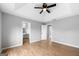 Main bedroom with tray ceiling, hardwood floors, neutral gray paint, and ensuite bathroom at 8103 Rhodes Way, Riverdale, GA 30274