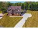 Spacious property featuring well-manicured lawns, mature trees, and a lengthy driveway at 4402 Kady Ct, Mcdonough, GA 30252