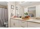 Bright bathroom featuring double vanity with granite countertop, white cabinetry, and decorative accessories at 4402 Kady Ct, Mcdonough, GA 30252