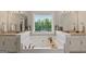 Relaxing bathroom featuring a tub beneath a window with double sinks and neutral walls at 4402 Kady Ct, Mcdonough, GA 30252