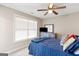 Neutral bedroom featuring a ceiling fan, and a large window with natural light at 4402 Kady Ct, Mcdonough, GA 30252