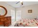 Cozy bedroom with a large window, ceiling fan, and classic furnishings at 4402 Kady Ct, Mcdonough, GA 30252