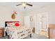 Bedroom featuring a ceiling fan, hardwood floors, and an attached bathroom at 4402 Kady Ct, Mcdonough, GA 30252