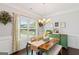 Bright dining room featuring a large window, designer accents, and a vintage green buffet at 4402 Kady Ct, Mcdonough, GA 30252