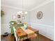 Elegant dining room with decorative touches and a vintage green buffet at 4402 Kady Ct, Mcdonough, GA 30252