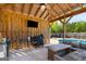 Gazebo featuring a grill area, outdoor television, ceiling fan, and lounge seating with views of the private backyard pool at 4402 Kady Ct, Mcdonough, GA 30252