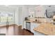 Bright kitchen featuring stainless steel appliances, granite countertops, and hardwood floors at 4402 Kady Ct, Mcdonough, GA 30252