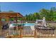 Inviting backyard pool area featuring lounge seating, a charming gazebo, and a privacy fence, perfect for outdoor entertaining at 4402 Kady Ct, Mcdonough, GA 30252