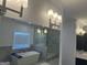 Bathroom mirror reflects a modern soaking tub, glass shower, and marble floors, creating a spa-like atmosphere at 906 Winall Down Ne Rd, Atlanta, GA 30319