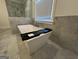 Modern soaking tub with elegant faucet, set against the backdrop of a marble-tiled bathroom at 906 Winall Down Ne Rd, Atlanta, GA 30319