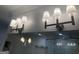 Bathroom featuring four vanity lights, large mirror, and glass shower at 906 Winall Down Ne Rd, Atlanta, GA 30319