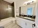 Elegant bathroom with herringbone tile, modern vanity, and sleek fixtures at 906 Winall Down Ne Rd, Atlanta, GA 30319