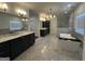 Large bathroom featuring dual sinks, soaking tub, glass shower, and marble floors for a spa-like experience at 906 Winall Down Ne Rd, Atlanta, GA 30319