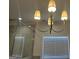 Bathroom with tub and shower, showcasing stylish light fixture, and marble tile detail at 906 Winall Down Ne Rd, Atlanta, GA 30319