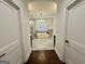 Elegant bathroom featuring a soaking tub, chandelier, and stylish fixtures at 906 Winall Down Ne Rd, Atlanta, GA 30319