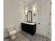 Elegant bathroom with patterned tile floor, dark vanity, and stylish sconces at 906 Winall Down Ne Rd, Atlanta, GA 30319