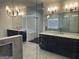 Elegant bathroom with marble floors, dual vanities, a glass-enclosed shower, and stylish light fixtures at 906 Winall Down Ne Rd, Atlanta, GA 30319