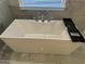 Contemporary bathtub with modern fixtures and marble tile surround at 906 Winall Down Ne Rd, Atlanta, GA 30319