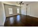 Spacious bedroom with gleaming hardwood floors, ceiling fan, and two windows letting in natural light at 906 Winall Down Ne Rd, Atlanta, GA 30319