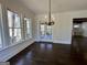 Dining room features hardwood flooring, a decorative chandelier, and access to the backyard at 906 Winall Down Ne Rd, Atlanta, GA 30319