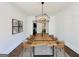 Bright dining room features a wooden table with seating for eight and modern light fixture at 906 Winall Down Ne Rd, Atlanta, GA 30319