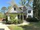 Charming two-story home featuring a well-manicured lawn and vibrant flower beds adding curb appeal at 906 Winall Down Ne Rd, Atlanta, GA 30319