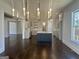 Open floor plan showcasing hardwood floors, a kitchen, living, and dining area with modern lighting at 906 Winall Down Ne Rd, Atlanta, GA 30319