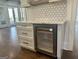 Kitchen bar with a built-in wine cooler and sleek marble countertops at 906 Winall Down Ne Rd, Atlanta, GA 30319