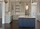 Kitchen with a blue island, white cabinets, marble countertops, and modern appliances at 906 Winall Down Ne Rd, Atlanta, GA 30319