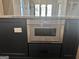 Kitchen island featuring a stainless steel microwave and stone countertop at 906 Winall Down Ne Rd, Atlanta, GA 30319