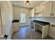 Bright laundry room featuring built-in cabinets, desk area and window at 906 Winall Down Ne Rd, Atlanta, GA 30319