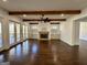 Living room with hardwood floors, wood beams, a stone fireplace, and backyard access at 906 Winall Down Ne Rd, Atlanta, GA 30319