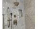 Shower with brushed nickel fixtures, with niche, and marble tile surround at 906 Winall Down Ne Rd, Atlanta, GA 30319