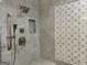 Luxurious shower with elegant marble tiling, dual showerheads, and decorative mosaic accent wall at 906 Winall Down Ne Rd, Atlanta, GA 30319