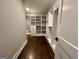 Spacious walk-in closet with custom built-in shelving and drawers, with mirror, offering ample storage at 906 Winall Down Ne Rd, Atlanta, GA 30319