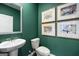 Stylish bathroom with a pedestal sink, classic fixtures, and elegant artwork at 2761 Honey Locust Court, Loganville, GA 30052