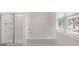 This bathroom has both a shower and a tub near a sunny window at 2761 Honey Locust Court, Loganville, GA 30052