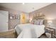 Charming bedroom with floral artwork, a soft bed, and a side table with a lamp at 2761 Honey Locust Court, Loganville, GA 30052